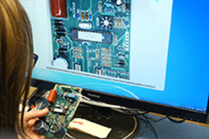 Employee quality checking circuit board on computer